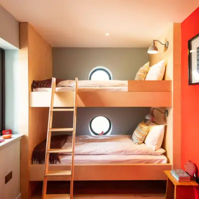 bunk room with double bed and round windows